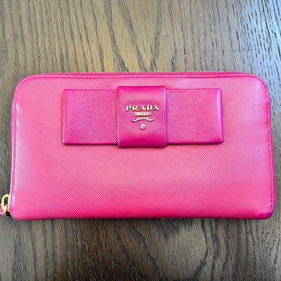 Prada Handbags - Pink Prada Saffiano Bow Zippy Wallet (Authentic)